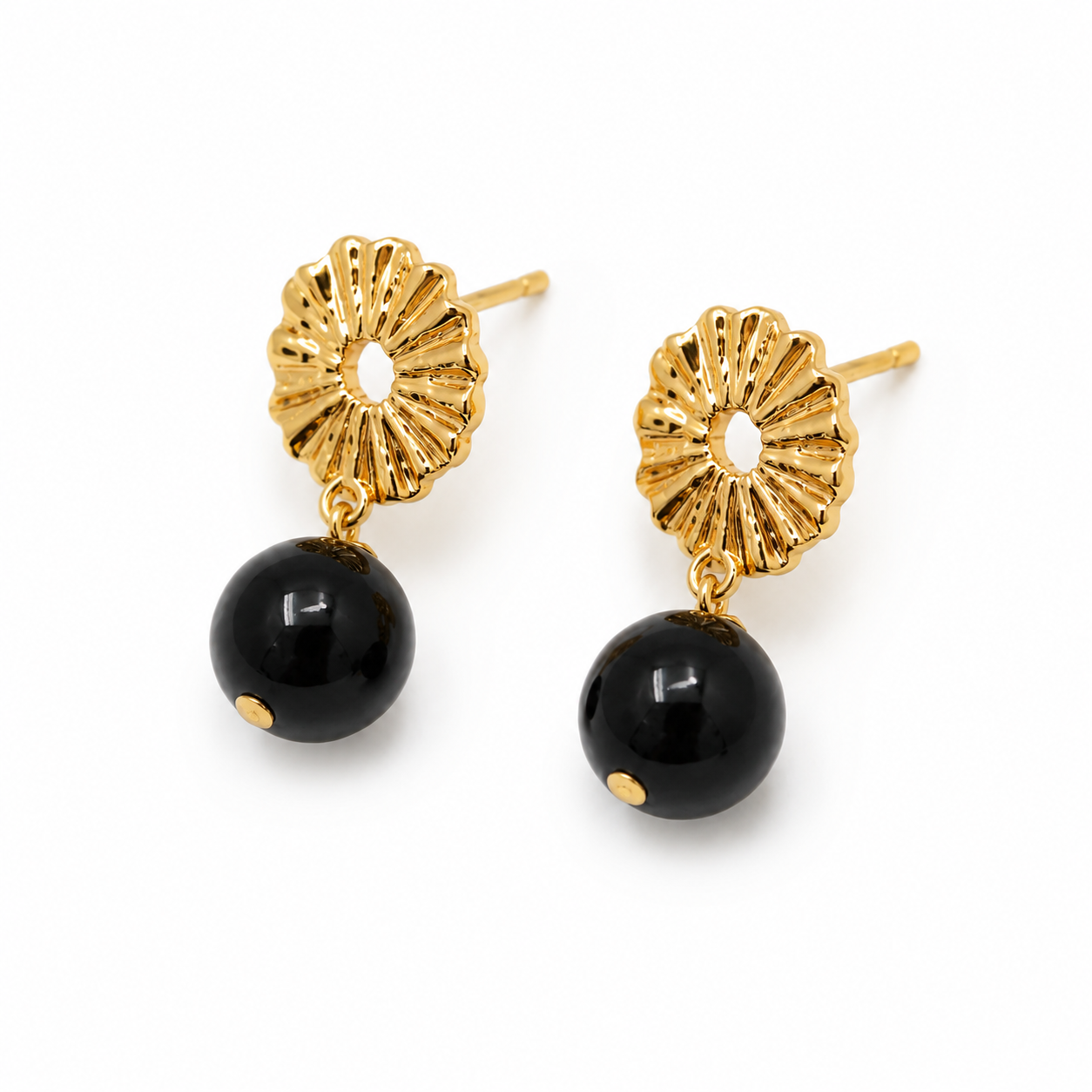 A pair of gold and black drop earrings featuring a textured, sunburst-shaped gold top and a smooth black spherical bead dangle, shown on a plain white background.